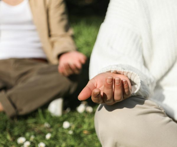Close-up of hands in a mindful gesture during exercise.